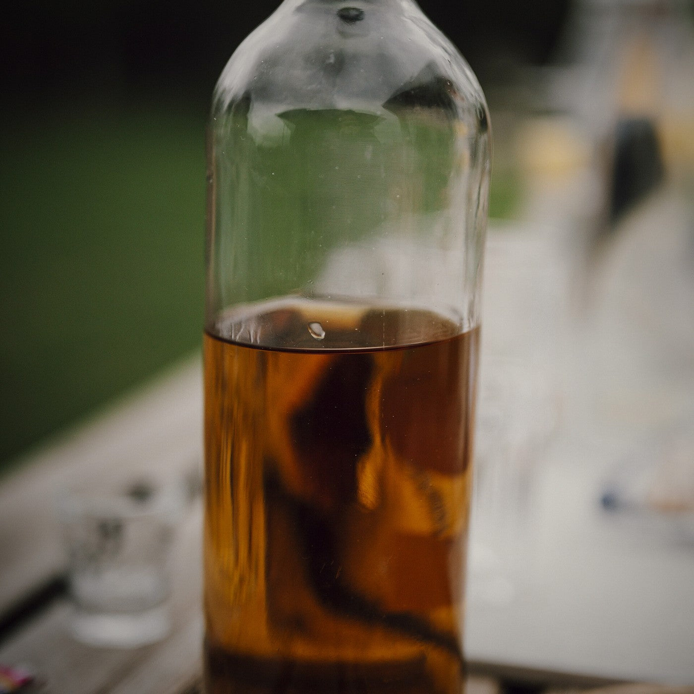 A bottle of oil on a wooden table